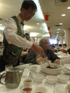 Our waiter serving  wonton soup