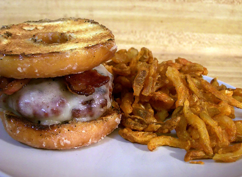 Picture of a Luther Burger and fries I made at home. It is comprised of lean beef, beef bacon, swiss cheese and a grilled Krispy Kreme doughnut. by Arlan Arthur Work is in the public domain
