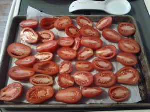 Fresh roma tomatoes cut and ready to go in the oven for DIY Sundried Tomatoes